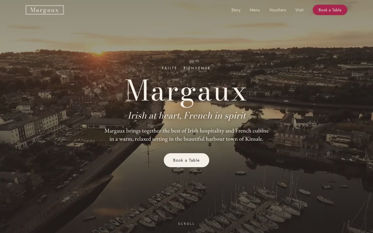Margaux homepage, a French restaurant in Kinsale, with drone footage of Kinsale harbour behind the brand